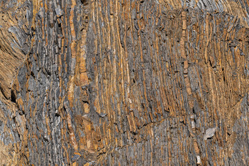 Natural rock structure showing geological layers and color changes, textural appearance of...
