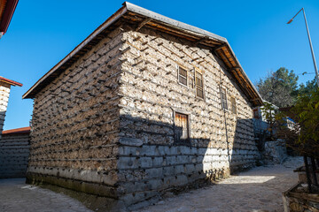 The traditional buttoned house architecture of Antalya İbradı, the unique harmony of stone and wooden frames.