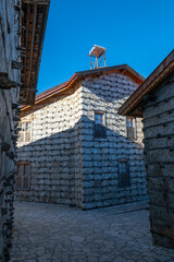 The narrow, stone-paved street lined with historic buttoned houses, showcasing the local architectural heritage and traditional Turkish village settlement.