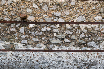 Traditional stone wall texture with wooden laths, rough plaster, and natural material details.