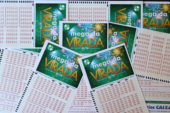Salvador, Brazil - December 24, 2025: Mega da Virada lottery tickets. Brazilian New Year's Eve 1 Billion Reais jackpot betting slips. Loterias Caixa Mega da Virada. Mega Sena. 