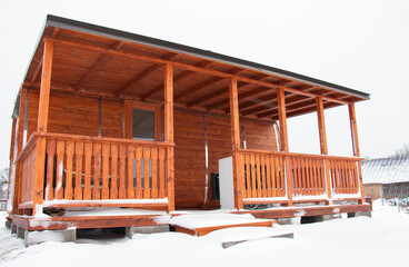 new home sauna made of wood, eco house in nature on a winter day. snow-covered fluffy spruce trees, walks through the winter white forest.