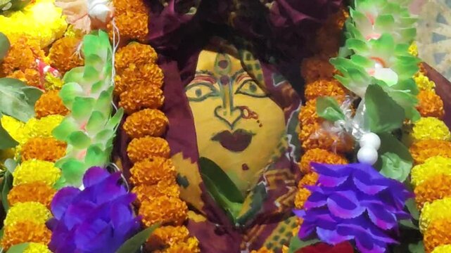 Close view of holy fire burning during Durga Puja worship in India. Decorated Durga idol, marigold flowers and ritual offerings create a spiritual Hindu festival atmosphere.
