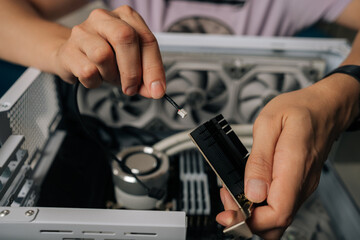 Skilled technician male hands inserting wireless network module inside computer tower, highlighting professional computer maintenance and hardware upgrade process. Concept of modern technology.