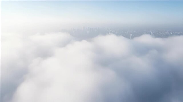 Aerial view of a city at sunset, showcasing the skyline through clouds with a vibrant gradient sky.