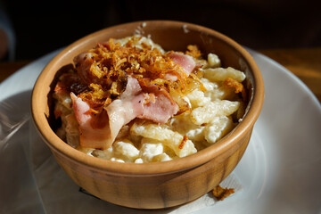 Traditional potatoes dumplings Halusky with Bryndza cheese and bacon, popular Slovak dish