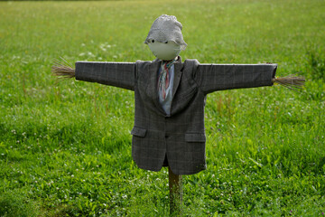 Historic scarecrow on meadow close-up view