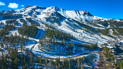 Aerial Mammoth Ski Area Snowy Mountain Road and Pine Forest California