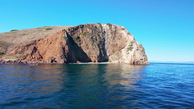 Tour boat approaching the rugged volcanic rock landing at Channel Islands National Park
