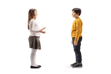 Obraz premium Full length profile shot of a young girl and boy having a conversation
