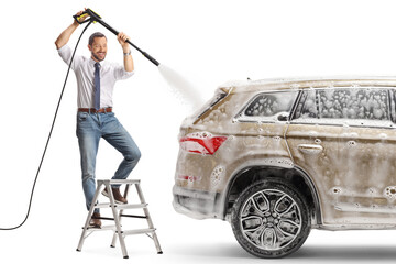 Man on a ladder washing a car with a high pressure machine