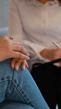 Nervous woman tapping fingers during therapy session