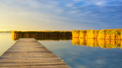 Wooden pier at sunrise on lake Velence Hungary