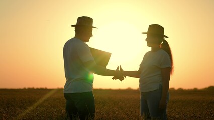 Businessmen shaking hands outdoors in sun. Teamwork man woman handshake. Farmers, man woman,...
