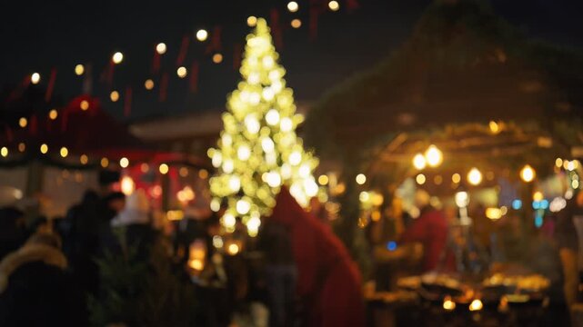 Vivid illuminated Christmas tree towers over lively marketplace scene with cheerful shoppers slow motion