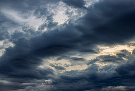 dark storm clouds at sunset - Powered by Adobe