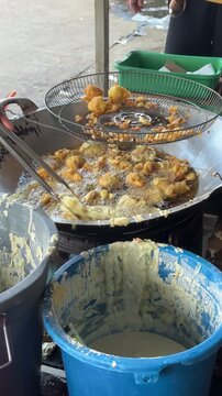 Making Indonesian Golden Crispy Fried Food on a Culinary Journey into Traditional Street Snack Preparation