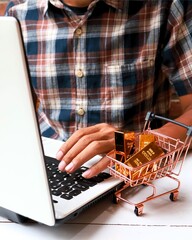 gold bars in a shopping cart with a man working on a laptop in the background