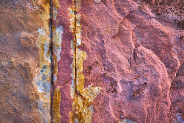Naklejka premium Colorful Rock Texture Close Up with Mineral Patterns and Weathered Surface