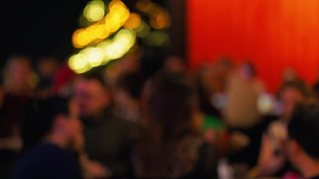 Audience laughing at comedy show, Spectators engrossed in humorous entertainment with warm lighting slow motion