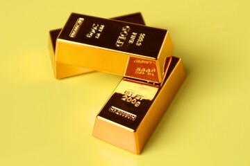 Stack of gold bars on yellow background