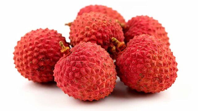 Fresh ripe lychee and dragon fruit isolated on white background with juicy red raspberries for a healthy tropical dessert