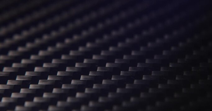 Close-up slide over the real carbon fiber texture background. 