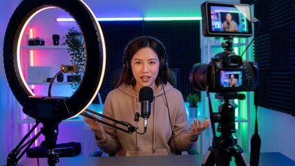 Solopreneur recording video content in home office with microphone camera ring light setup for streaming podcasting creative workspace