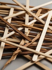 Scattered collection of wooden ice cream sticks in disarray, chaotic state
