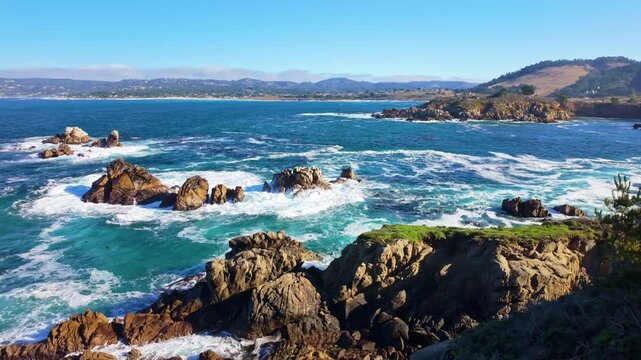 Pacific Ocean waves strike rugged coastal cliffs at Point Lobos State Natural Reserve in California