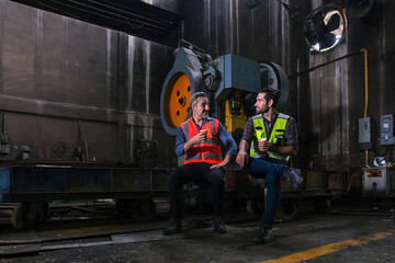 Engineer train engine service team working together at train depot locomotive industry Electric train technician engineer checking controls system for security functions in maintenance infrastructure 