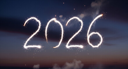 Sparkling fireworks display forming the year 2026 against a dark night sky with clouds at dusk or dawn