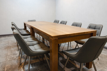 Large wooden table in modern boardroom