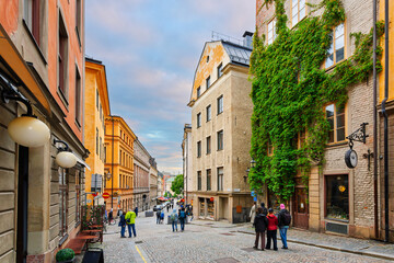 The picturesque Storkyrkobrinken street, a historic, charming cobblestone street through the medieval Gamla Stan old town in Stockholm, Sweden.