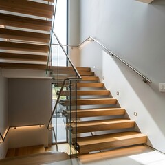 Modern staircase with wooden steps, glass railings, and steel handrails