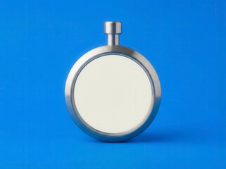 Round stainless steel sight glass with a bright white opaque liquid against a blue background
