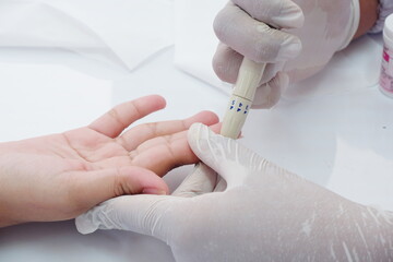 Blood glucose testing in progress using a digital glucose meter and test strip.