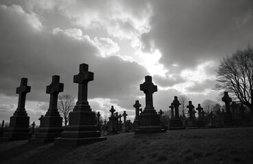 Old stone gravestones stand in rows at a vast cemetery under a dramatic cloudy sky. Bare trees are visible behind the crosses and tombstones. The atmosphere is somber, dark, and eerie.