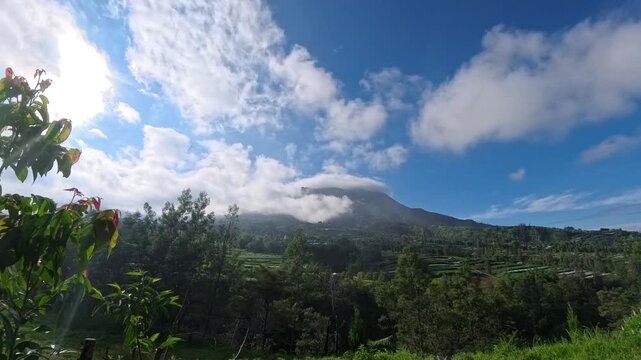 Timelapse of clouds over Mount Merapi volcano. Useful for travel, nature, and documentary themes