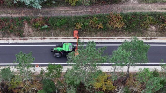 Green tractor plant maintenance with side boom moower