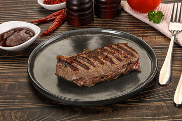 Grilled beef striploin steak with sauce