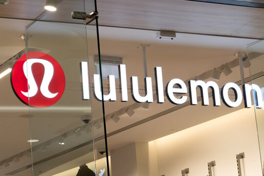 London, UK - January 09 2025: Illustrative editorial Lululemon logo and illuminated store sign on glass storefront inside shopping centre
