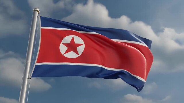 North Korean flag waving in the wind against cloudy blue sky