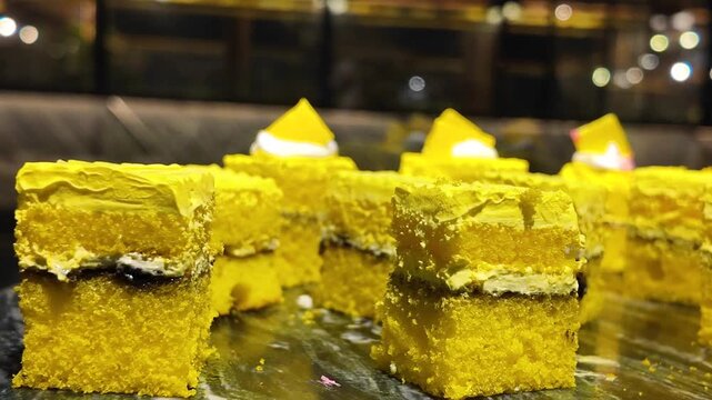 Sweet yellow cake pieces on a serving plate at a cafe
