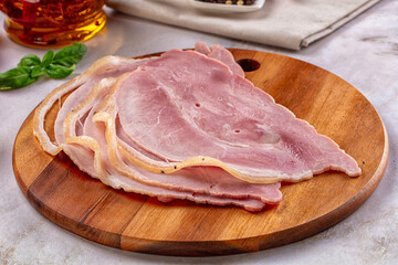 Sliced pork ham over board