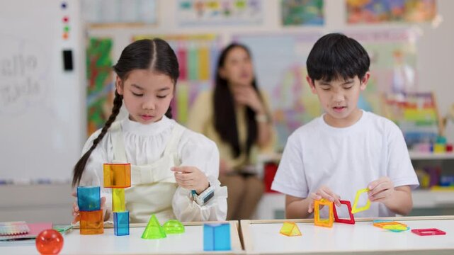 Asian Children Building Geometric Shapes in Classroom STEM Activity
