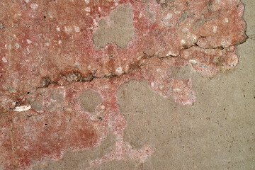 Red Grunge Concrete Wall Texture. Rough concrete wall with red stains and distressed surface. Bold grunge texture for posters, covers and urban visuals.