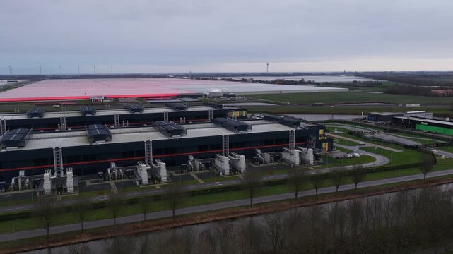 Close up aerial video of emergency backup power generators and cooling systems at a redundant data center, highlighting large scale computing, storage, and AI infrastructure.