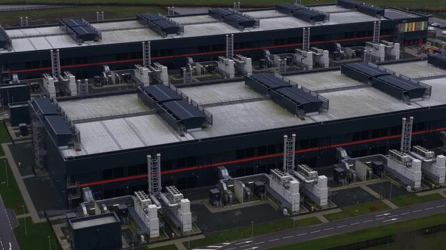 Close up aerial view of a large scale redundant data center at Agriport in Middenmeer, The Netherlands, featuring colocation services, AI infrastructure, and high performance computing systems.