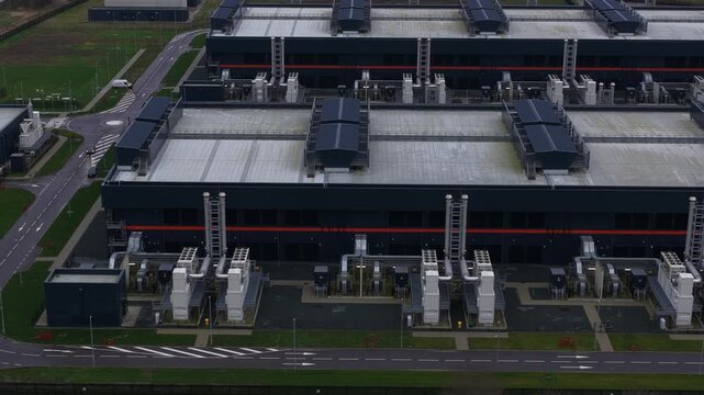Close up aerial view of a large scale redundant data center at Agriport in Middenmeer, The Netherlands, featuring colocation services, AI infrastructure, and high performance computing systems.
